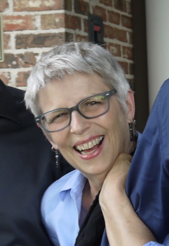 Nancy Lorraine Anderson smiling in front of a brick wall